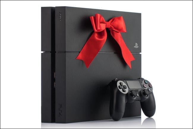 A PlayStation 4 console with a bow on it.