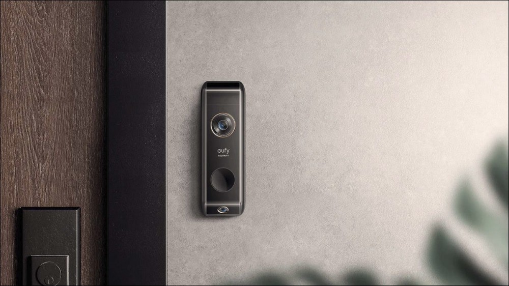 A Eufy doorbell, installed outside a modern apartment.