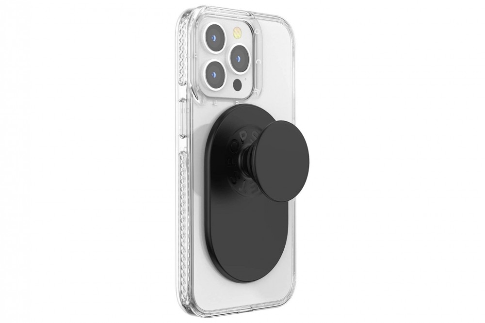 The backside of a gray iPhone with the black PopSocket attached to it.