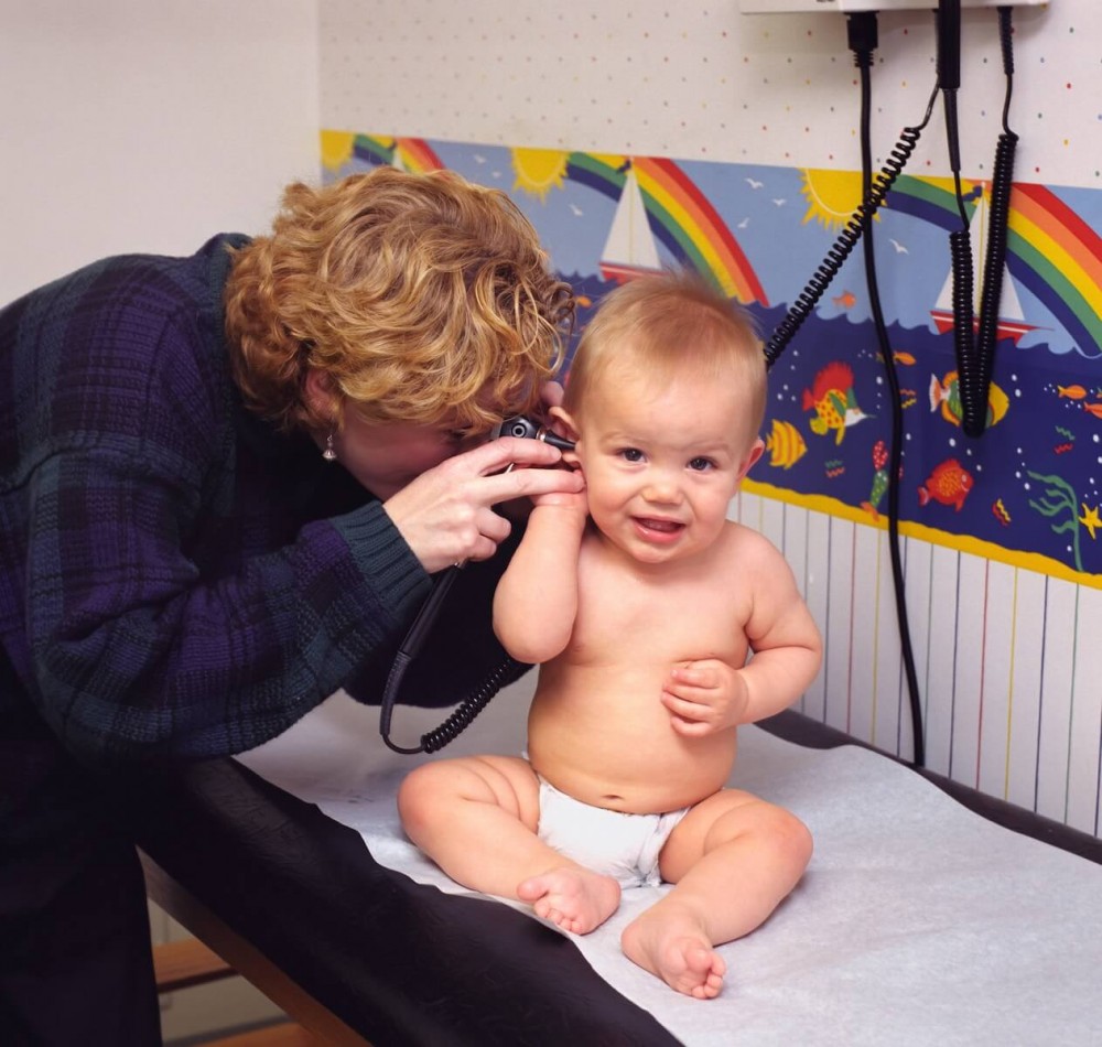 doctor examining baby's ear